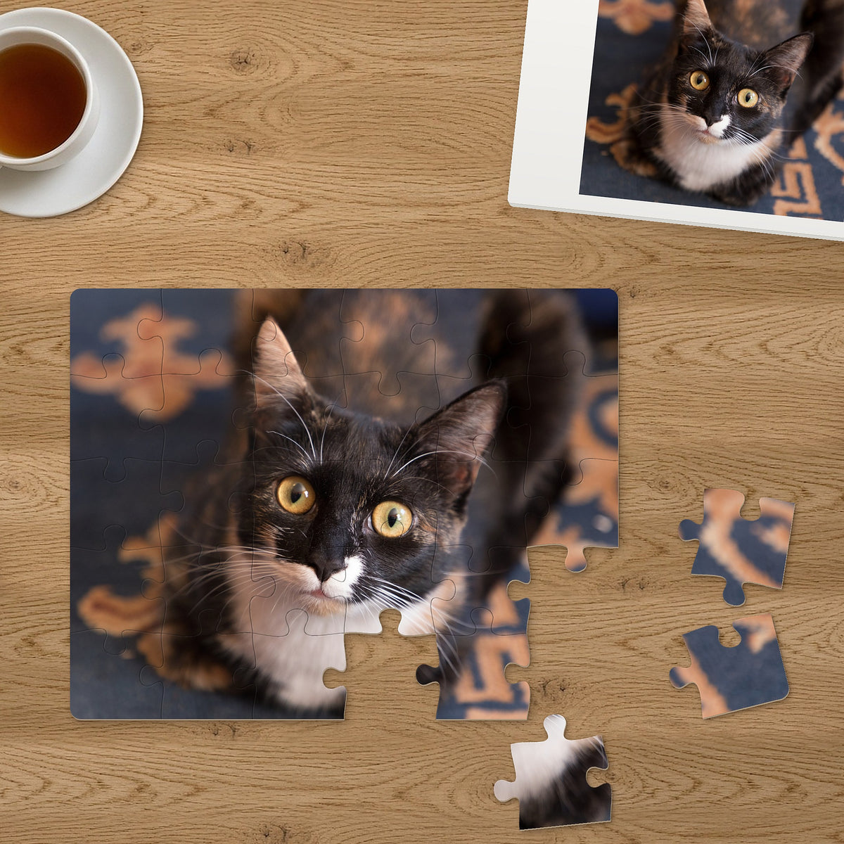 Memory Lane puzzle: Calico Kitten. Three of the 30 extra-large pieces, each about 2¼″ across, lifted out beside the puzzle (product illustration)