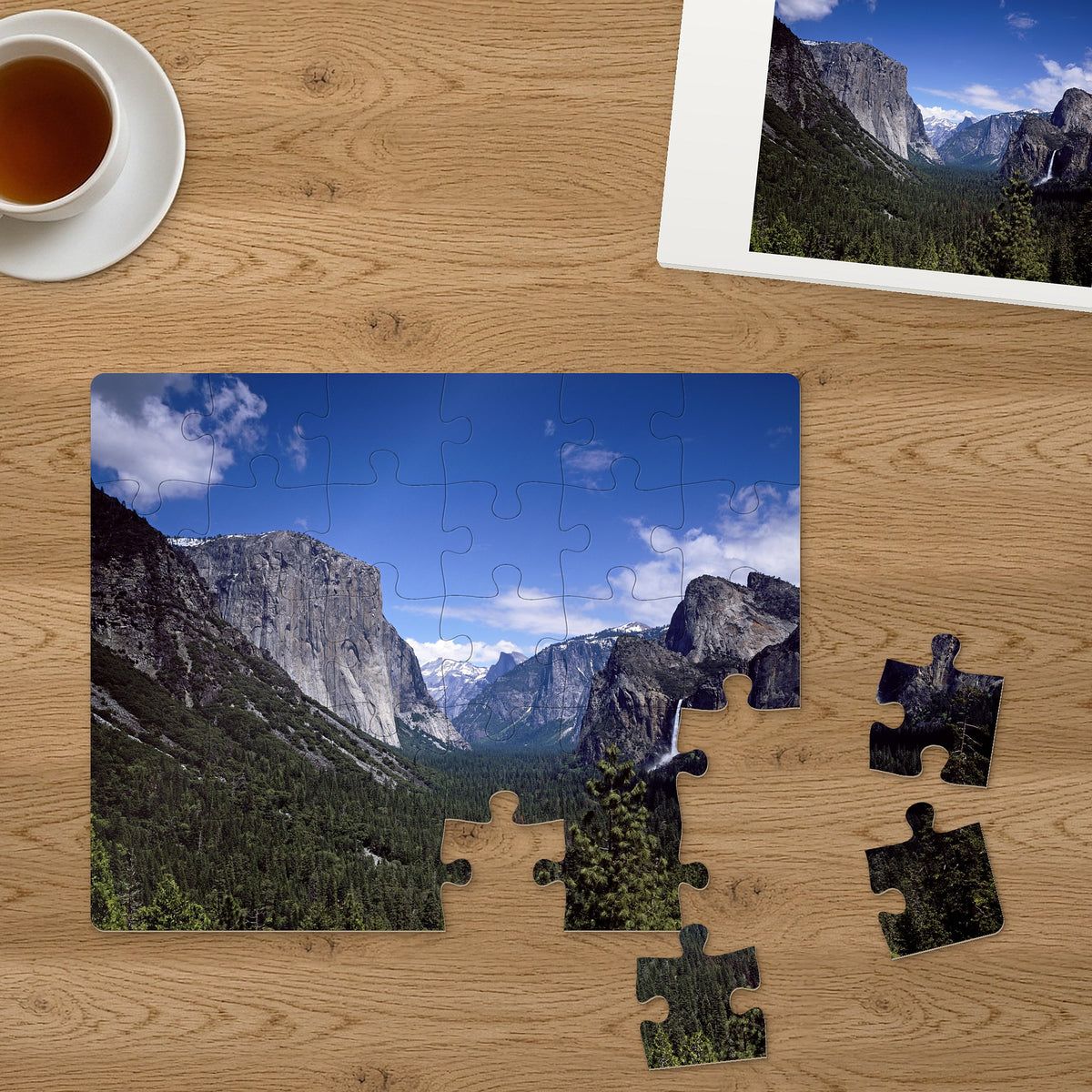 Memory Lane puzzle: Yosemite Valley View. Three of the 30 extra-large pieces, each about 2¼″ across, lifted out beside the puzzle (product illustration)