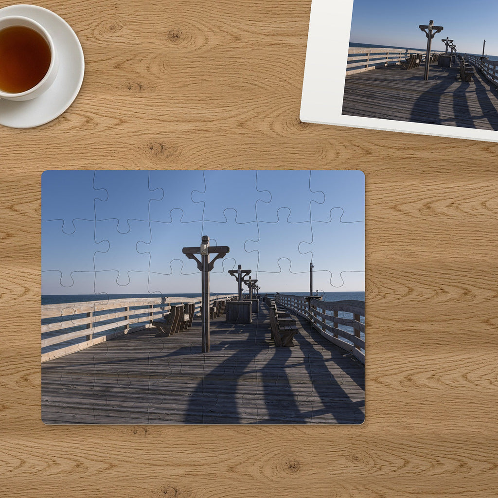 Memory Lane puzzle: Seaside Pier. The finished 30-piece 14″ × 11″ puzzle on a table beside its white gift box (product illustration)