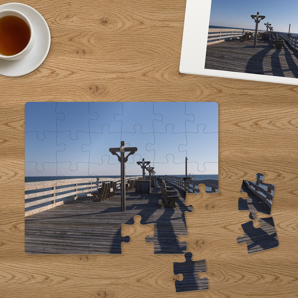 Memory Lane puzzle: Seaside Pier. Three of the 30 extra-large pieces, each about 2¼″ across, lifted out beside the puzzle (product illustration)