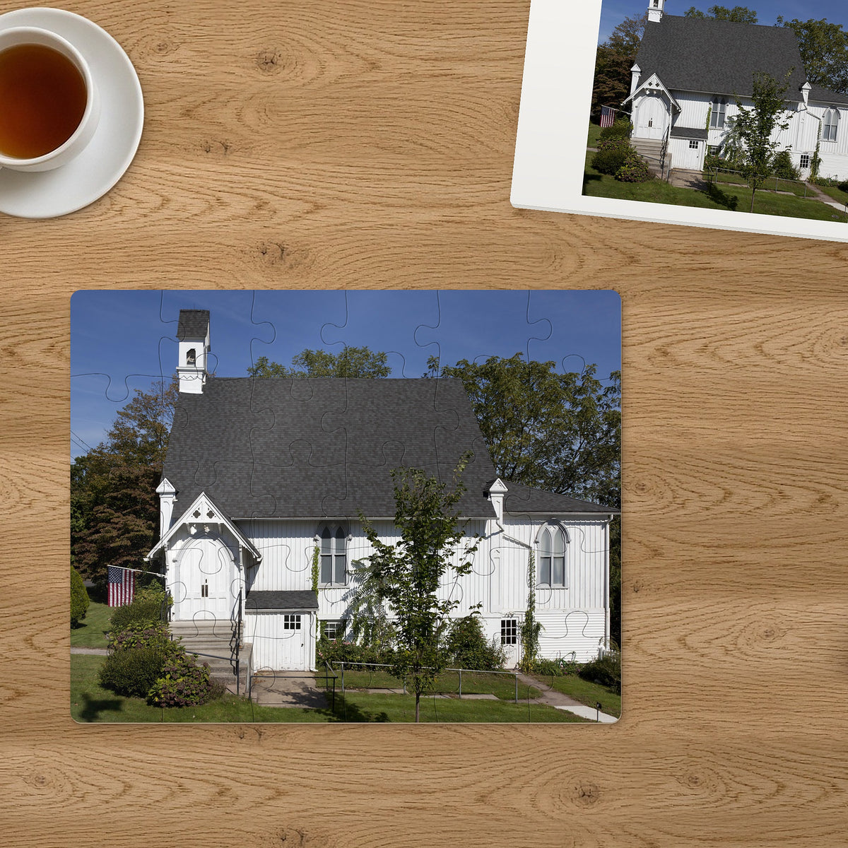 Memory Lane puzzle: Little White Chapel. The finished 30-piece 14″ × 11″ puzzle on a table beside its white gift box (product illustration)