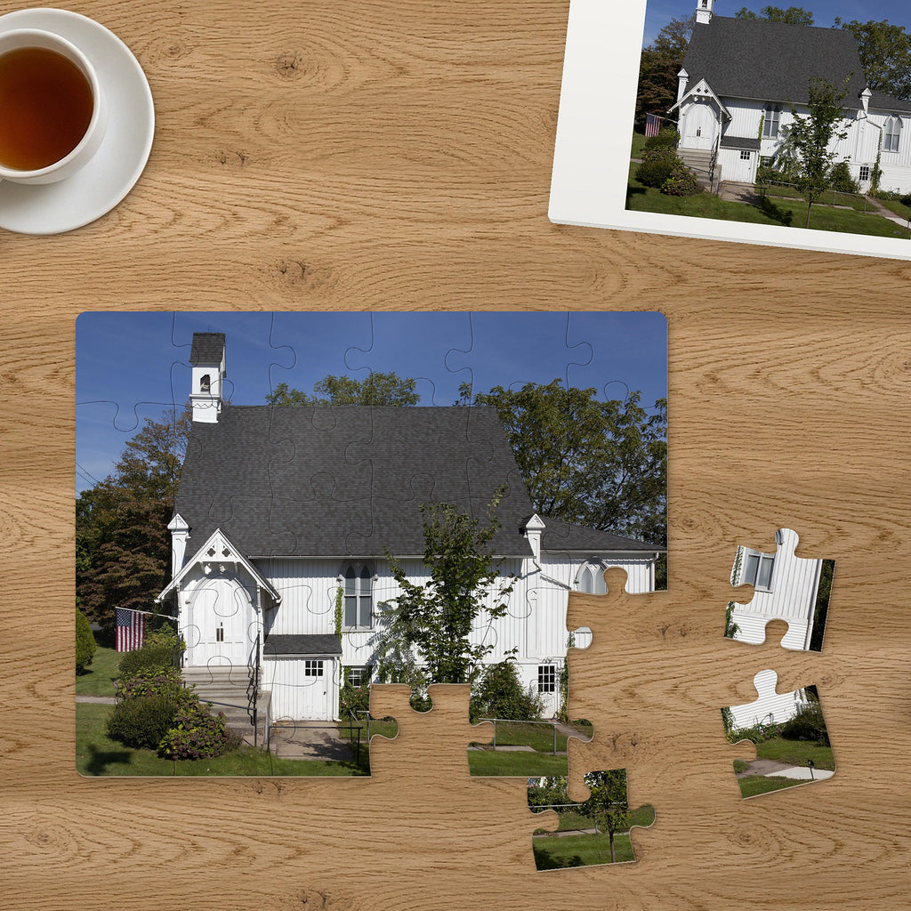 Memory Lane puzzle: Little White Chapel. Three of the 30 extra-large pieces, each about 2¼″ across, lifted out beside the puzzle (product illustration)